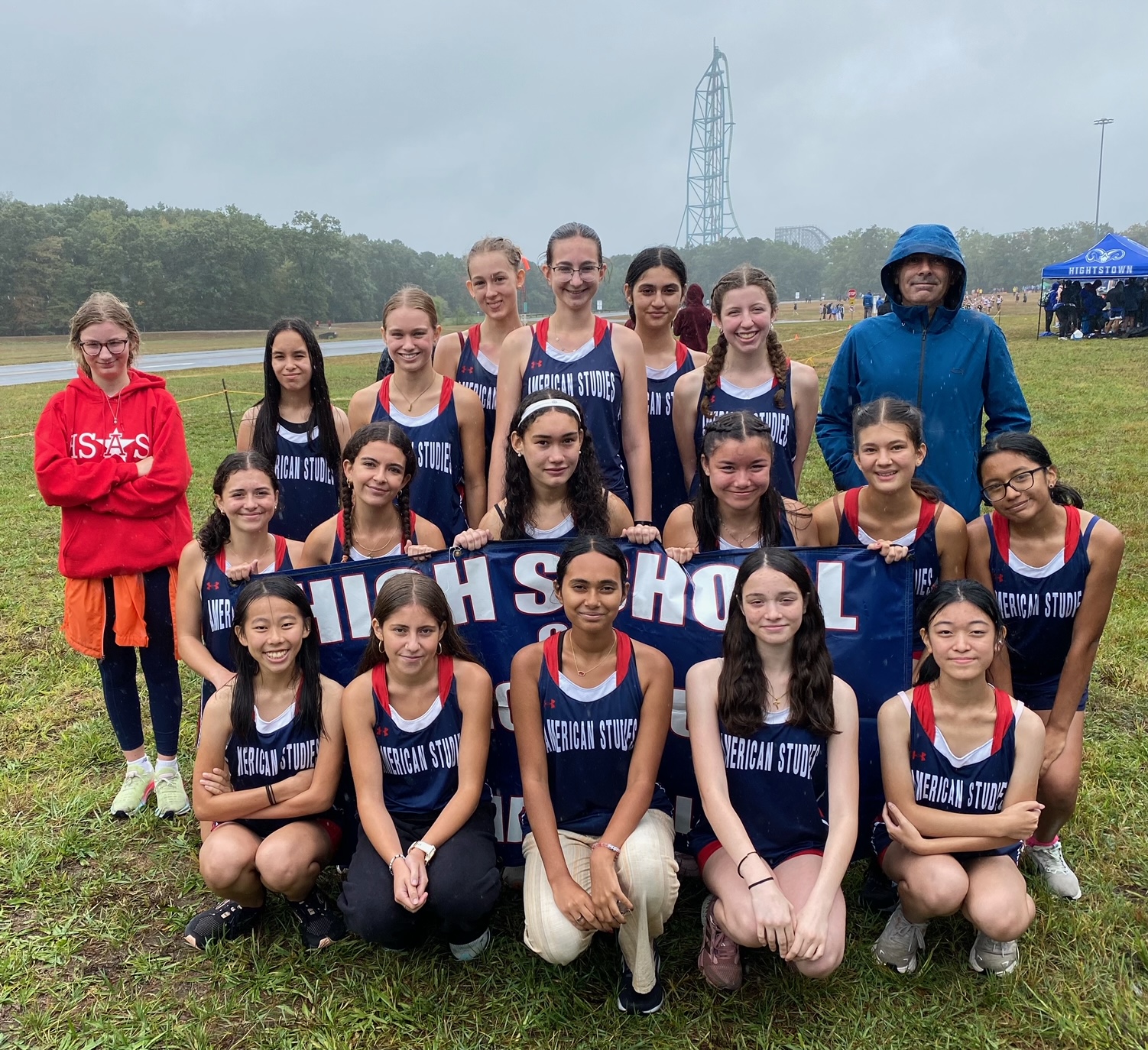 18 members of the Women's XC Team pose with their coach.