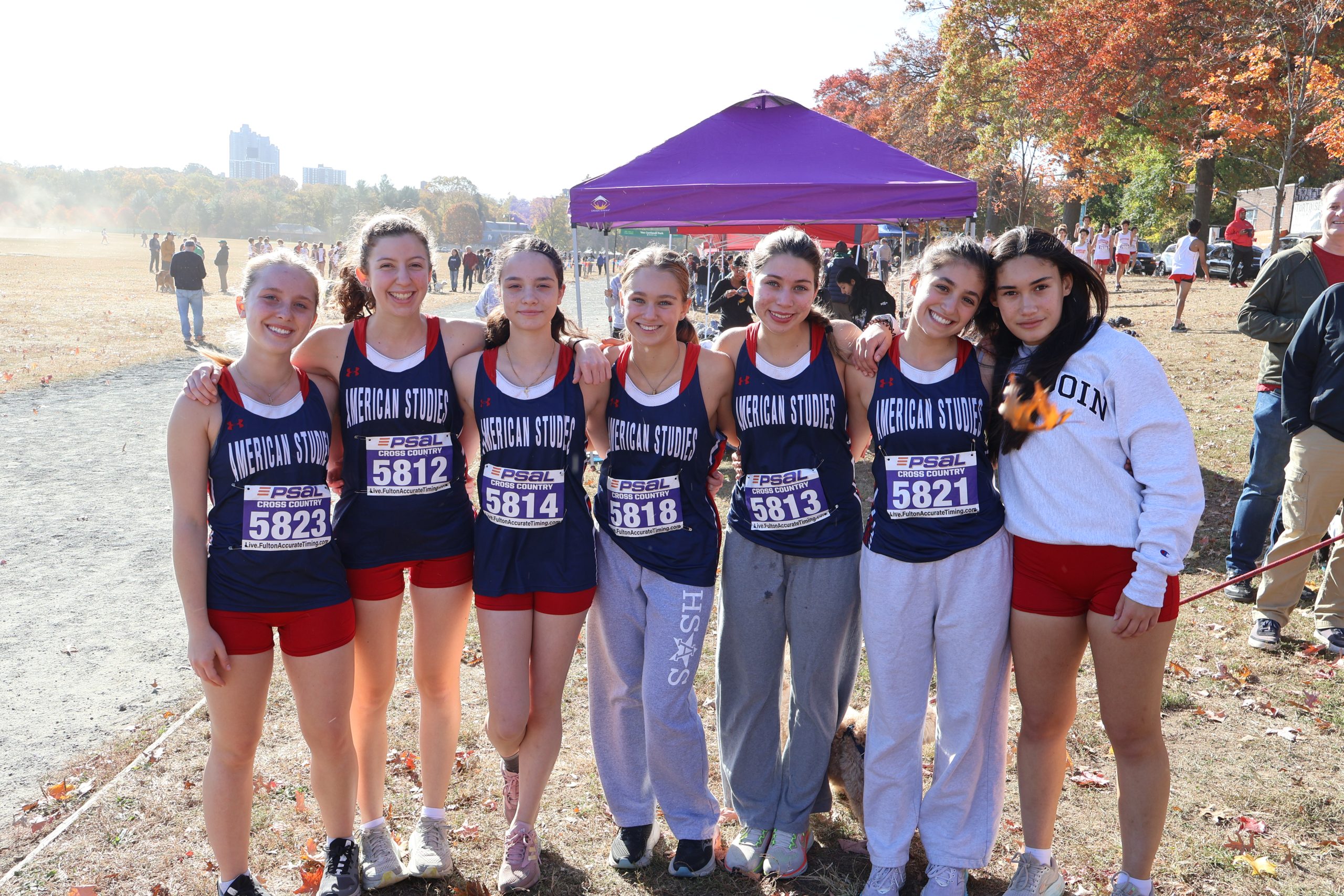 Seven Varsity team members stand side by side facing the camera.