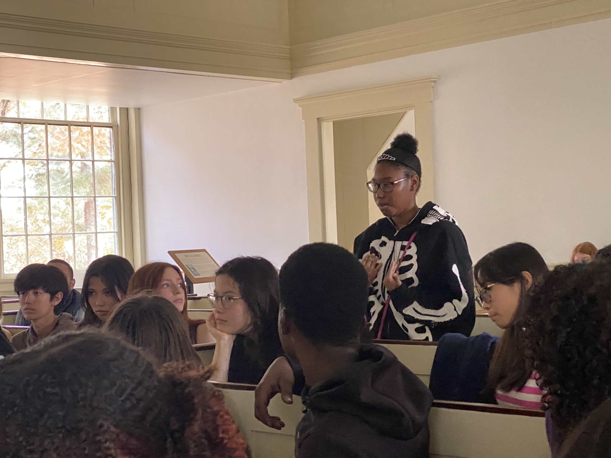 Student stands in front of classmates.