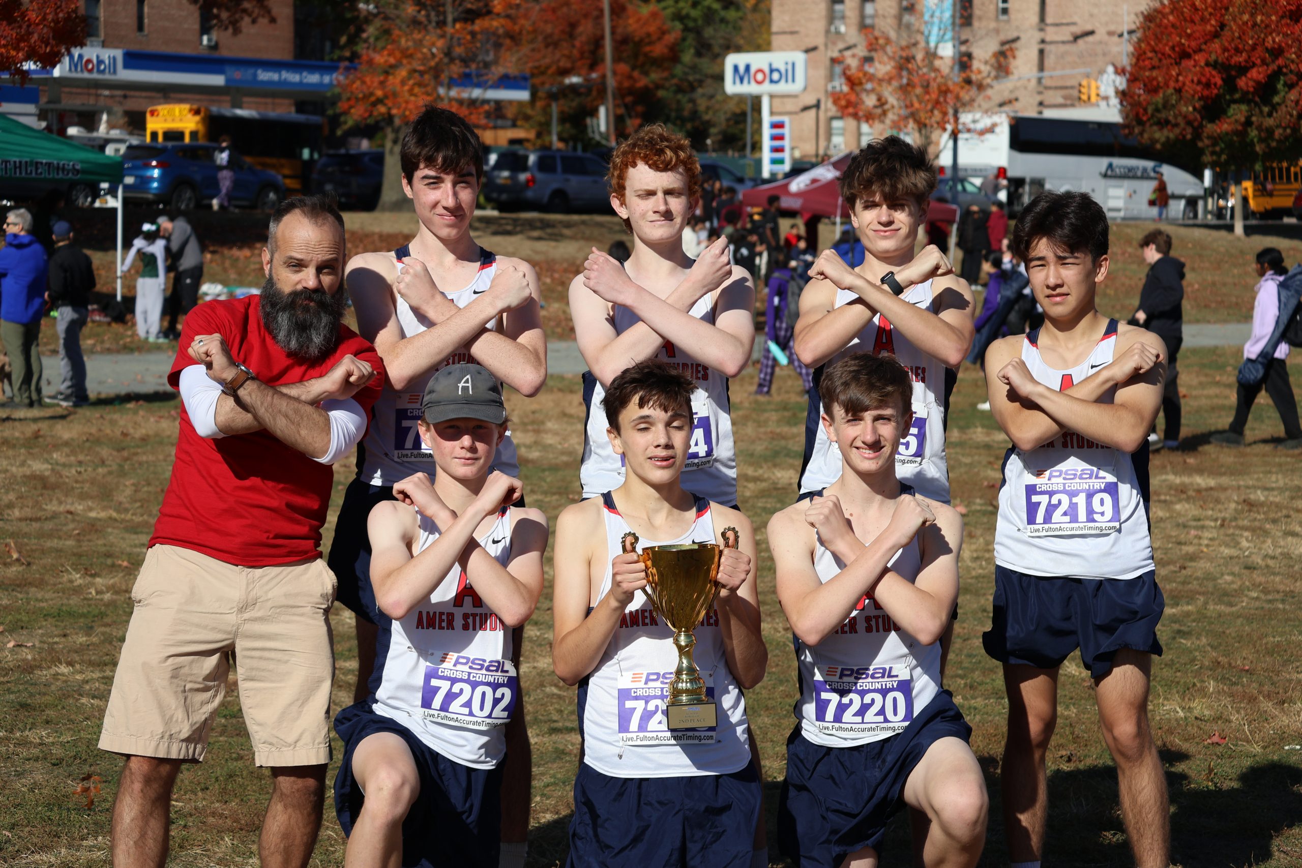 Members of the Varsity steam stand in two rows crossing their arms in a X shape.