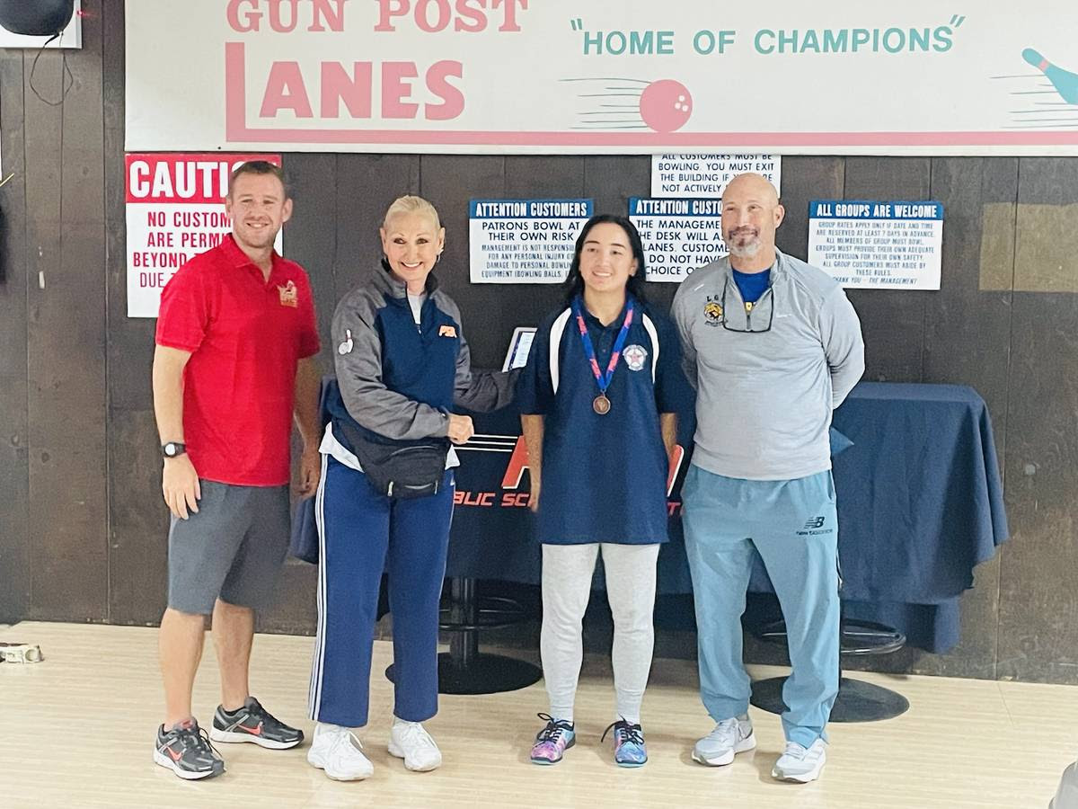 Winning student stands alongside commissioners from the PSAL Bowling league.