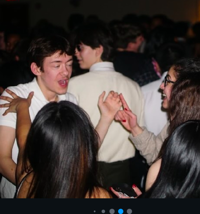 A few students face one another and dance.