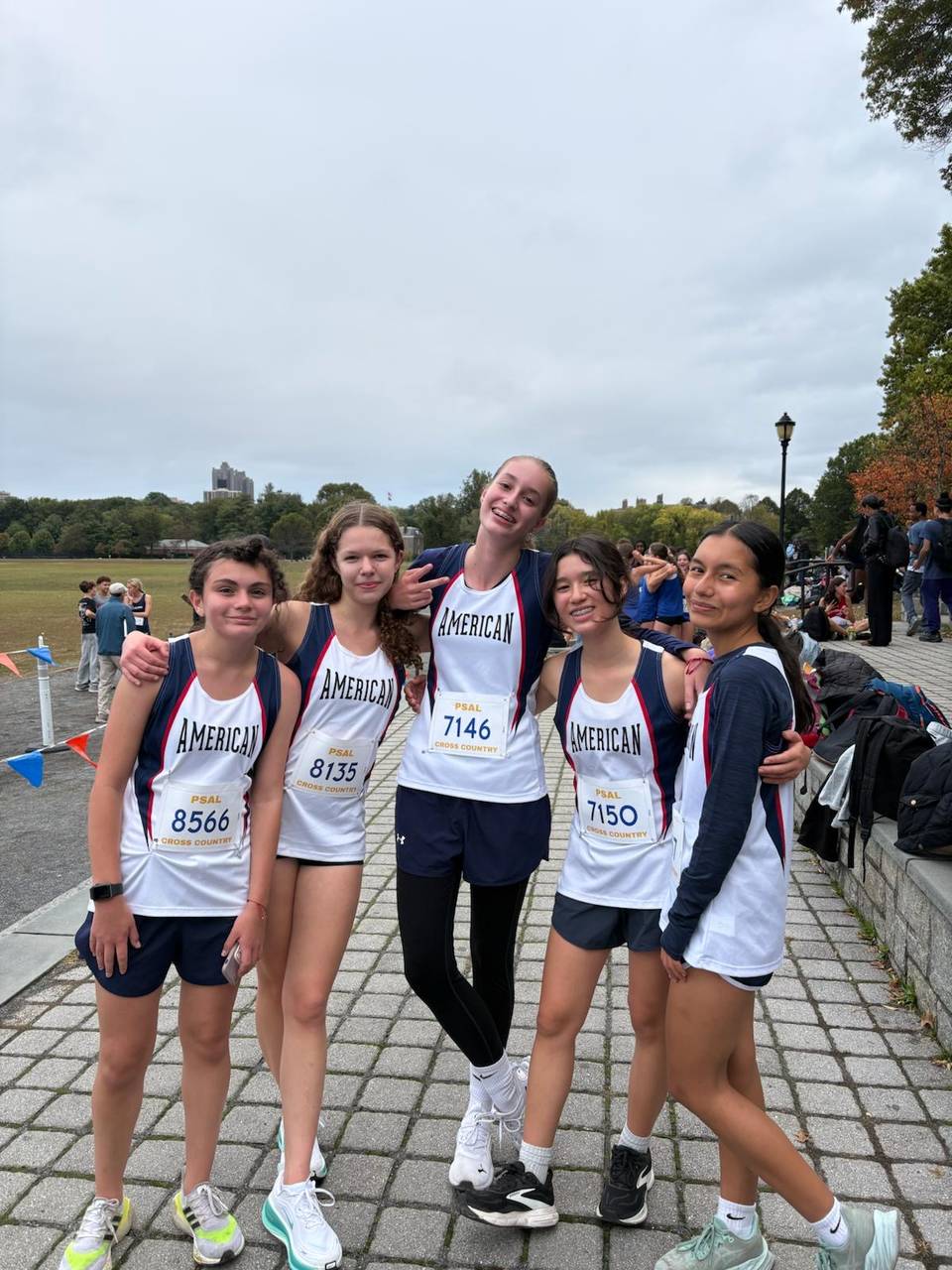 five girls wearing Running Uniforms stand side by side.