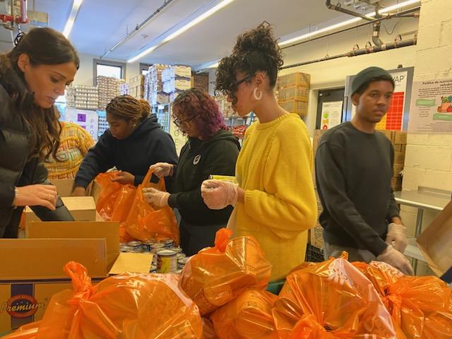 Five students are loading food baskets