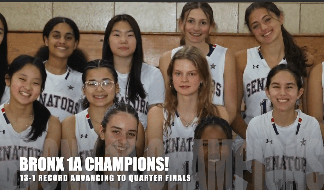 Members of the girls basketball team sit on bleachers in three tiers.
