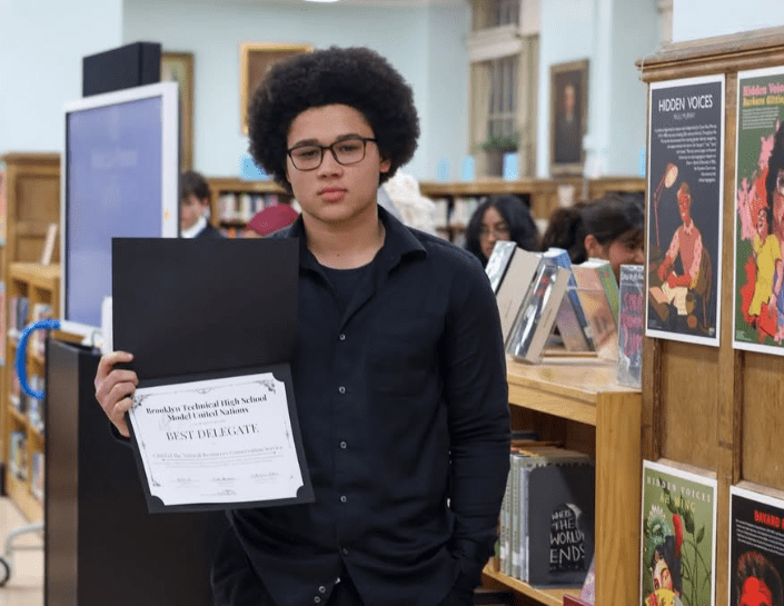 Student poses with certificate