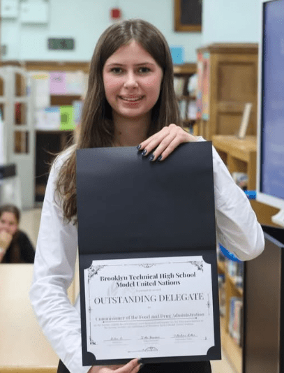 Student poses with certificate