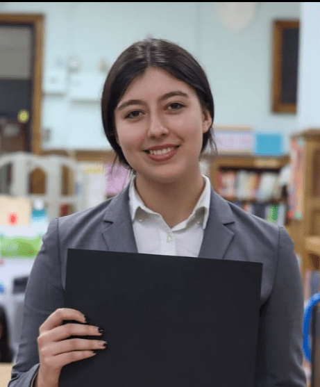 Student poses with certificate