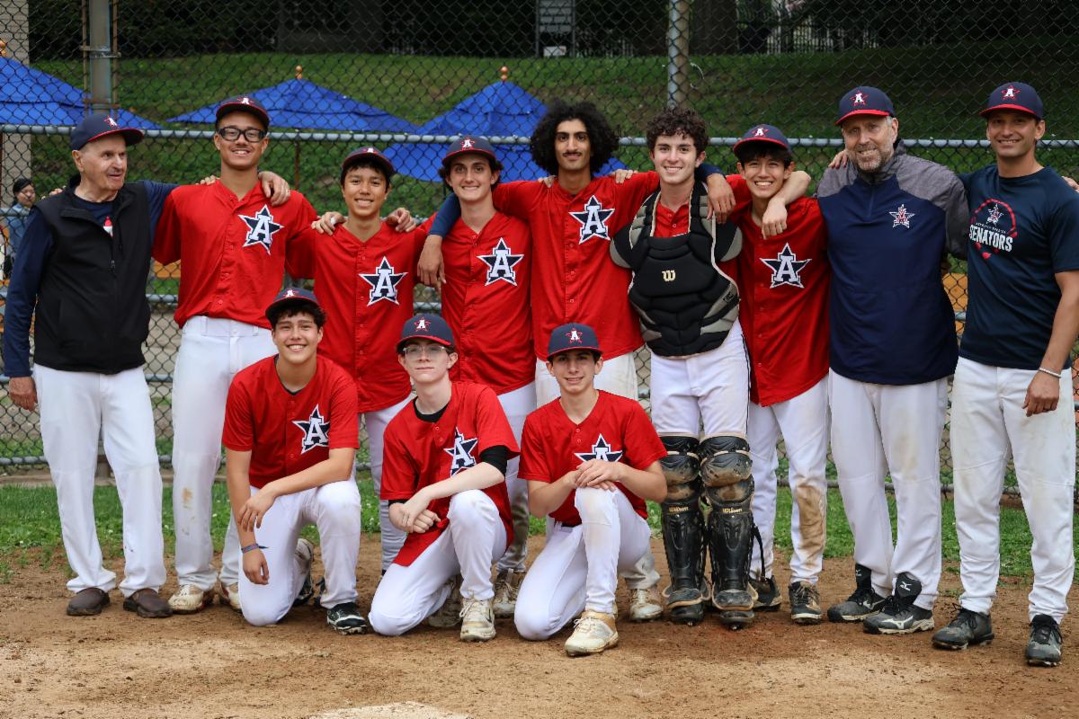 Baseball team poses with their coach.