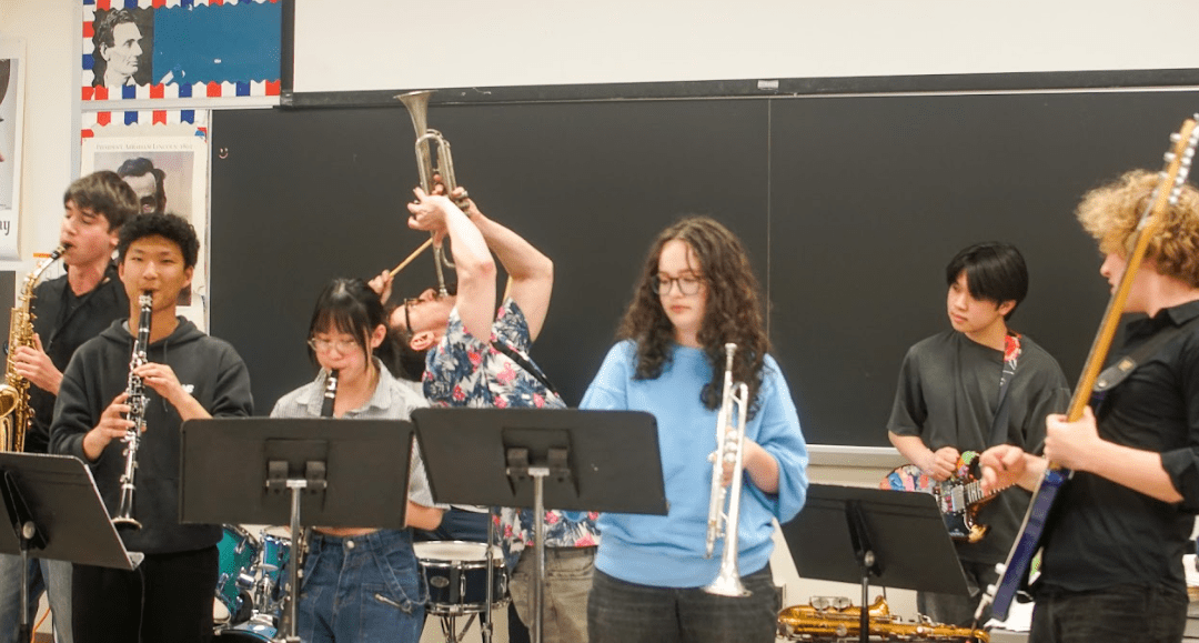 Student Jazz Band stand playing multiple instruments.