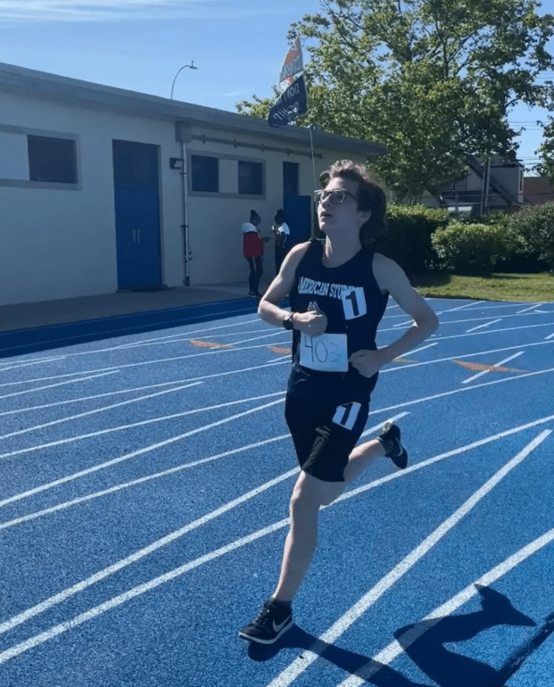 Solo runner leads the race on a track.
